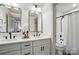 Bright bathroom featuring a double vanity, modern mirrors and a shower-tub combination at 343 Melbourne Ct, Charlotte, NC 28209