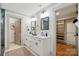 Bathroom with double vanity, modern fixtures, and a walk-in closet at 343 Melbourne Ct, Charlotte, NC 28209