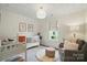Cozy Bedroom with a white crib, gray chair, plush rug, and patterned ceiling at 343 Melbourne Ct, Charlotte, NC 28209