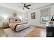 Calming bedroom featuring hardwood floors, ceiling fan, neutral walls, and natural light at 343 Melbourne Ct, Charlotte, NC 28209