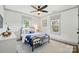 Relaxing bedroom featuring an inviting bed, two large windows and hardwood flooring at 343 Melbourne Ct, Charlotte, NC 28209