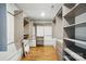 Spacious walk-in closet with custom shelving and drawers, and wood floor at 343 Melbourne Ct, Charlotte, NC 28209