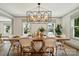Bright dining room featuring a long wooden table, stylish chairs, and abundant natural light at 343 Melbourne Ct, Charlotte, NC 28209