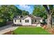 Charming exterior of a white two-story home with a well-manicured lawn and beautiful landscaping at 343 Melbourne Ct, Charlotte, NC 28209