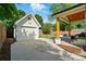 A detached garage situated in a beautifully landscaped backyard with an outdoor lounge area at 343 Melbourne Ct, Charlotte, NC 28209