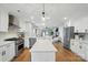 Open concept kitchen with large island, stainless steel appliances, and hardwood floors at 343 Melbourne Ct, Charlotte, NC 28209