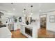 Modern kitchen with stainless appliances, white cabinets, and island with built-in microwave at 343 Melbourne Ct, Charlotte, NC 28209