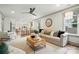 Spacious living room with hardwood floors, a ceiling fan, and an open view to the kitchen at 343 Melbourne Ct, Charlotte, NC 28209