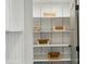 Pantry with custom shelving and Herringbone tile backsplash at 343 Melbourne Ct, Charlotte, NC 28209