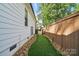 Turf, gravel and pavers create a beautiful side yard between the house and privacy fence at 343 Melbourne Ct, Charlotte, NC 28209