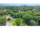 This shot shows a lovely neighborhood with the Charlotte skyline in the distance, all surrounded by lush trees at 3615 Kempton Pl, Charlotte, NC 28208