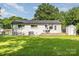 Spacious backyard with lush green lawn, patio, storage shed, and privacy fence at 3615 Kempton Pl, Charlotte, NC 28208