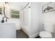 Updated bathroom featuring tiled shower/tub, new vanity, and modern fixtures at 3615 Kempton Pl, Charlotte, NC 28208