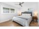 Comfortable bedroom with hardwood floors, neutral color scheme, and natural light from the windows at 3615 Kempton Pl, Charlotte, NC 28208