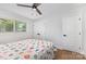 Cozy bedroom features a ceiling fan, natural light, and hardwood floors at 3615 Kempton Pl, Charlotte, NC 28208