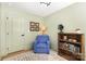 A stylish bedroom has a soft blue armchair, lamp, and bookshelves at 3615 Kempton Pl, Charlotte, NC 28208