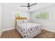 Inviting bedroom with stylish bed frame, hardwood flooring, and natural light from multiple windows at 3615 Kempton Pl, Charlotte, NC 28208