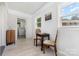Bright room with natural light, wood-look flooring, chess table, chairs, and laundry at 3615 Kempton Pl, Charlotte, NC 28208
