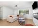 Cozy living room features a sectional sofa, layered coffee tables, and large bright window at 3615 Kempton Pl, Charlotte, NC 28208