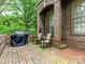 Charming brick patio with outdoor seating and grill, perfect for entertaining at 4026 Barclay Downs Dr, Charlotte, NC 28209