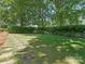 Expansive backyard with lush greenery and a stone walkway, ideal for relaxation and recreation at 4026 Barclay Downs Dr, Charlotte, NC 28209