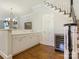 Bright bar area featuring a white countertop, cabinets, and a wine cooler near the staircase at 4026 Barclay Downs Dr, Charlotte, NC 28209