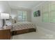 Comfortable bedroom featuring neutral color tones, ample natural light, and a TV on the wall at 4026 Barclay Downs Dr, Charlotte, NC 28209