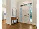 Bright foyer features hardwood floors and a view into the kitchen at 4026 Barclay Downs Dr, Charlotte, NC 28209