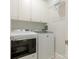 Bright laundry room featuring a Maytag washer and dryer and ample cabinet space for storage at 4026 Barclay Downs Dr, Charlotte, NC 28209