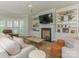 Cozy living room with built-in shelving, fireplace, and bay window at 4026 Barclay Downs Dr, Charlotte, NC 28209