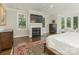 Spacious main bedroom with a fireplace, TV, and bay window with natural light at 4026 Barclay Downs Dr, Charlotte, NC 28209