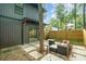Backyard featuring patio area, outdoor seating, and a modern home exterior with sliding glass doors at 411 Granby Cir, Charlotte, NC 28217
