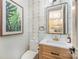 Stylish half-bathroom featuring modern fixtures, unique wallpaper, and elegant decor at 411 Granby Cir, Charlotte, NC 28217