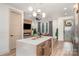 Open-concept kitchen with a spacious island, modern lighting, and a view into the living area at 411 Granby Cir, Charlotte, NC 28217