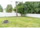 Spacious fenced backyard with green lawn and a fire pit, ideal for outdoor activities and relaxation at 435 Riverwalk Nw Dv, Concord, NC 28027