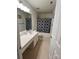 This bathroom features a large mirror, vanity, and a shower and tub combo at 435 Riverwalk Nw Dv, Concord, NC 28027