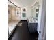 Modern bathroom featuring dual sinks, gray vanity, and an open shower at 435 Riverwalk Nw Dv, Concord, NC 28027