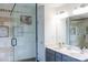 Bathroom with a glass shower, vanity with dual sinks, and modern lighting fixtures at 435 Riverwalk Nw Dv, Concord, NC 28027