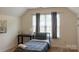 Bright and airy bedroom featuring a vaulted ceiling, carpet flooring, and a light gray accent wall at 435 Riverwalk Nw Dv, Concord, NC 28027