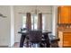 Bright dining area showcasing an elegant light fixture, a window, and cabinet storage at 435 Riverwalk Nw Dv, Concord, NC 28027