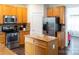 Well-equipped kitchen featuring stainless steel appliances, a center island, and an abundance of wooden cabinets at 435 Riverwalk Nw Dv, Concord, NC 28027