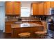 Bright kitchen featuring stainless steel appliances, granite countertops, and an abundance of wooden cabinets at 435 Riverwalk Nw Dv, Concord, NC 28027