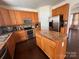 Bright kitchen with wooden cabinets, stainless steel appliances, granite countertops, and a center island at 435 Riverwalk Nw Dv, Concord, NC 28027