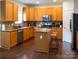 Bright kitchen with wooden cabinets, stainless steel appliances, and a center island with bar seating at 435 Riverwalk Nw Dv, Concord, NC 28027