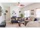 Bright living room featuring a fireplace, a ceiling fan, and a comfortable seating area at 435 Riverwalk Nw Dv, Concord, NC 28027