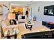 Open-concept living room with plenty of seating, natural light, and view into the well-equipped kitchen at 435 Riverwalk Nw Dv, Concord, NC 28027