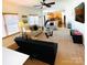 Cozy living room with neutral tones, ceiling fan, and view to the kitchen at 435 Riverwalk Nw Dv, Concord, NC 28027