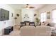 Bright living room featuring a fireplace, a ceiling fan, and a comfortable seating area at 435 Riverwalk Nw Dv, Concord, NC 28027