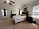 Primary bedroom with fan, windows, carpet, and dark furniture at 435 Riverwalk Nw Dv, Concord, NC 28027