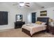 Primary bedroom with fan, windows, carpet, and dark furniture at 435 Riverwalk Nw Dv, Concord, NC 28027